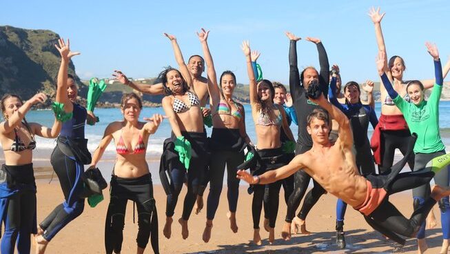 People cheering on the beach with Bio Surf Camp