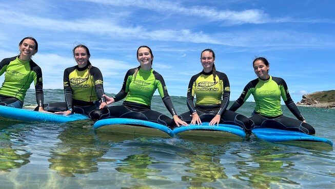 Learner surfers in the water on their surfboard with Bio Surf Camp