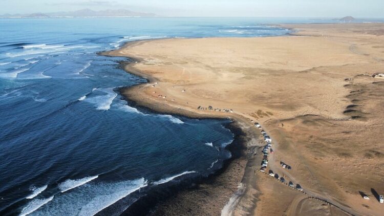 drone view of a Canary Islands surf and yoga camp with ocean and desert