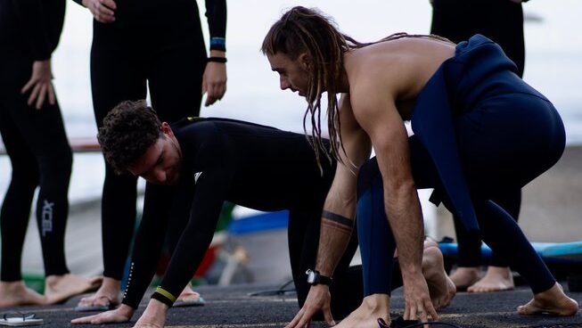 People learning how to surf with Dharmanas Yoga surf camp