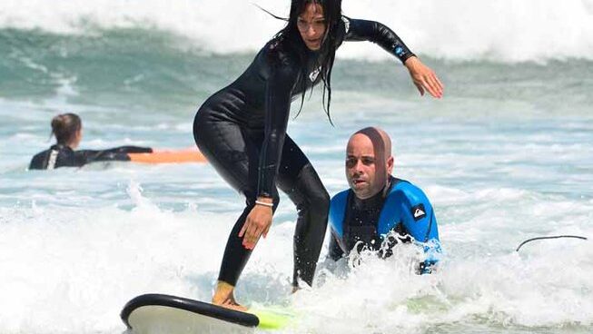 A girl learning how to surf with Escuela Cantabra De Surf Quicksilver Roxy