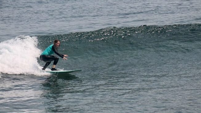 A surfer learning how to surf with Kubu Surf School