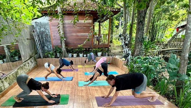 People posing for yoga with Kubu Surf School