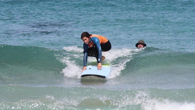 Someone learning how to surf at Line Up Fuerteventura surf camp