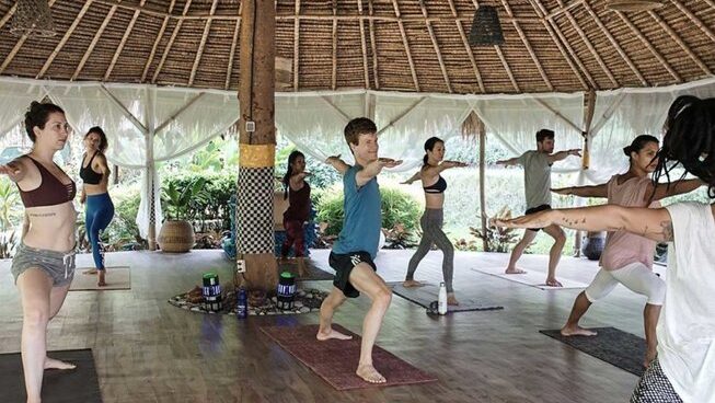 People practicing yoga at Mondo Surf & Lifestyle Village
