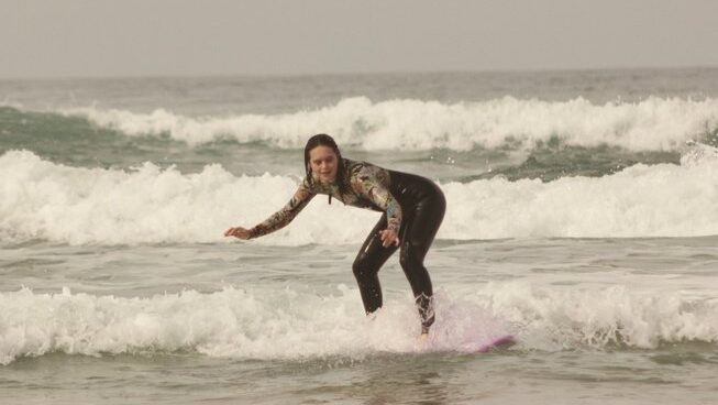 a girl learning how to surf at Sunny Wave Taghazout surf camp