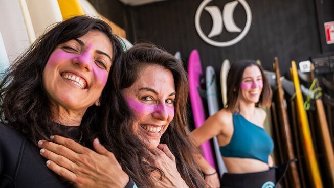 Two happy girls about surf with Surf Club El Palmar surf camp