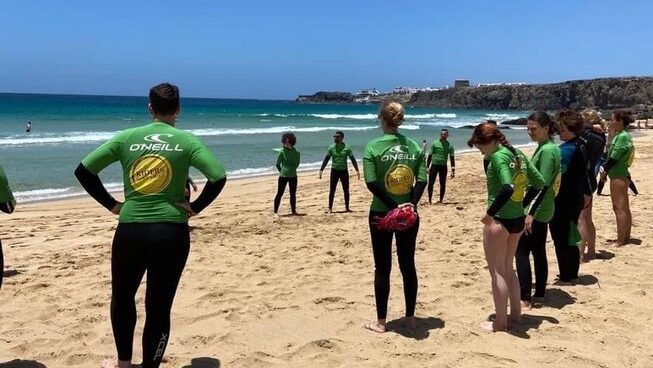 learner surfers on the beach with Tai Chi Fuerteventura Wellbeing Retreat