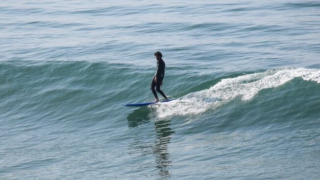 A surfers riding a wave in Tamraght