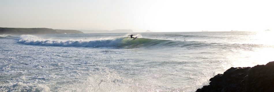 a surfer doing a turn on a wave during his time at the best surf camps in Spain
