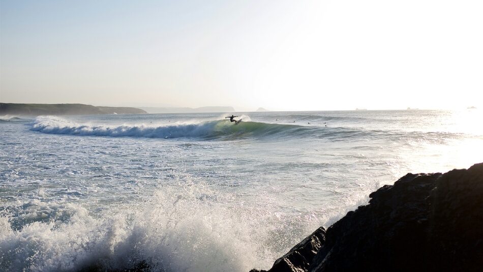 a surfer doing a turn on a wave during his time at the best surf camps in Spain