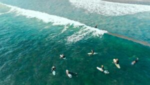 Surfers in the water waiting for a wave during an Affordable Surf Hostel Peniche