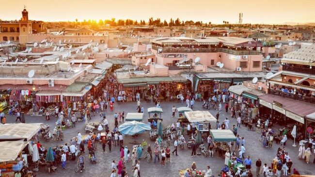 Market in Marrakech with the sunsetting in the distance