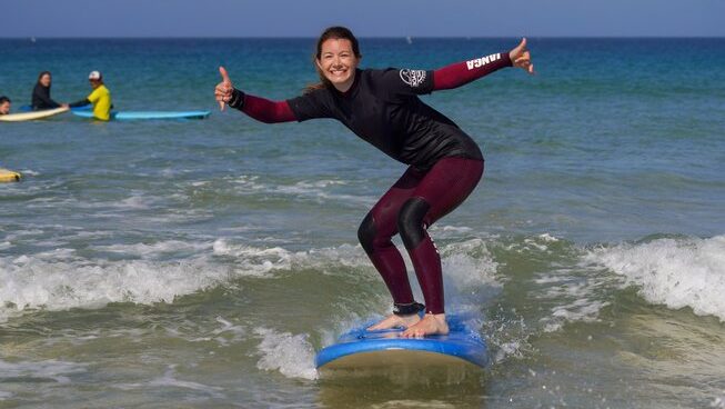 a learner surfer on a wave during a surf hostel Peniche