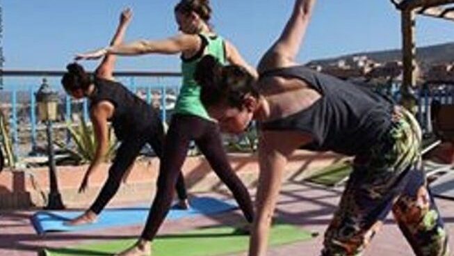Students practicing yoga at a Taghazout surf camp and yoga retreat