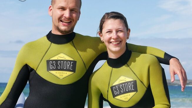 Two surfers learning how to surf at a surf hostel Peniche