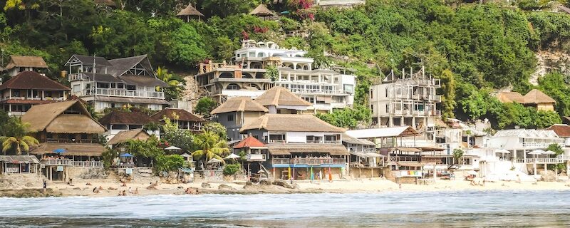 a water shot looking in to the hills with hotels and wonder is a surf camp worth it