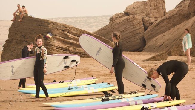 surfers putting on leg ropes at a Taghazout surf camp and yoga retreat