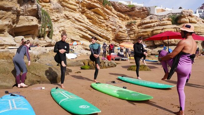 Learner surfers walking up before Imsouane surf