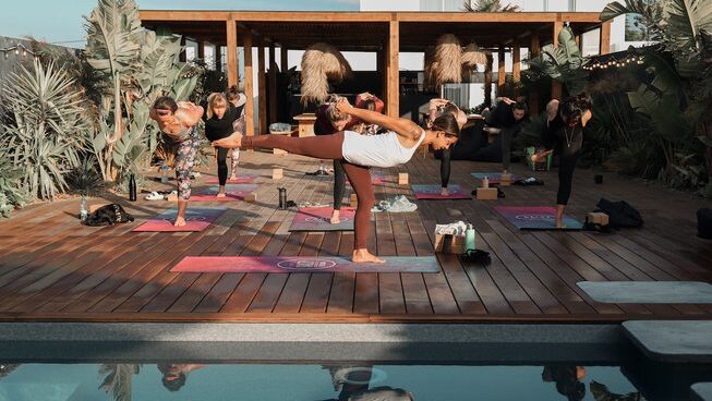 people practicing yoga at a surf hostel Peniche