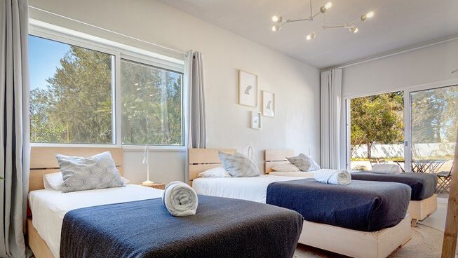 three single beds at Tiny Whale Surf Lodge Lagos surf camp