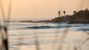 an empty wave with the sun setting and people wondering when is Morocco surf good