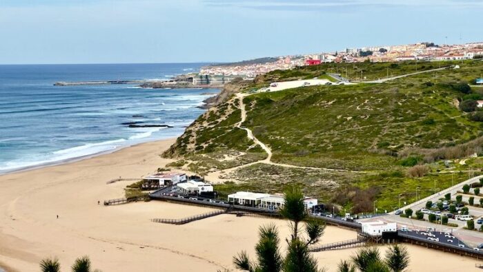 The beaches of Ericeira with green hills and houses