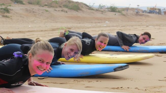 People on surfboards on the sand
