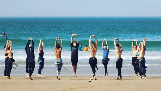 People warming up on the beach in Tamraght