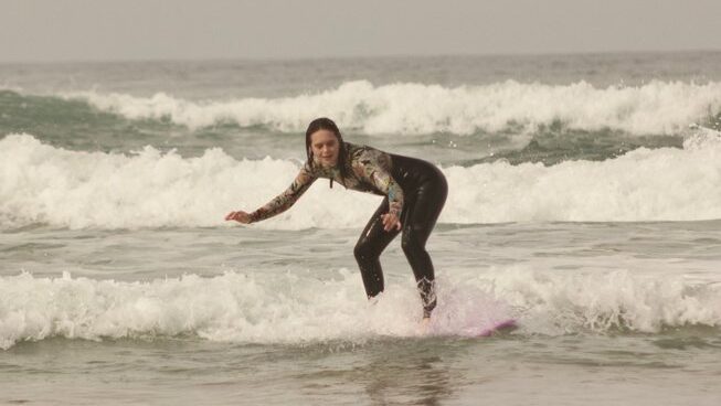 a learner surfer on a wave with Paddle Out Morocco