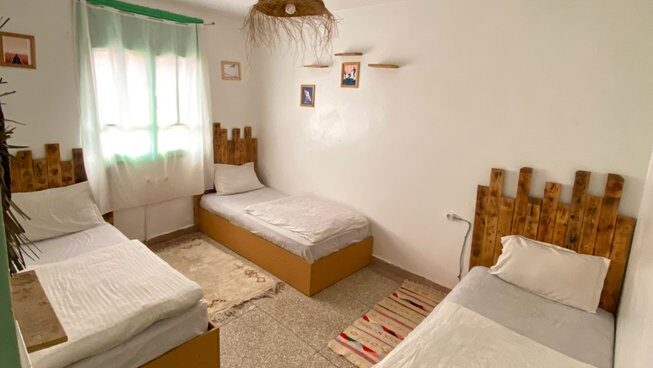 a room with 3 beds at Paddle Out Morocco surf camp
