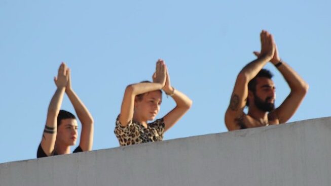People doing yoga with blue skies at Paddle Out Morocco Surf Camp