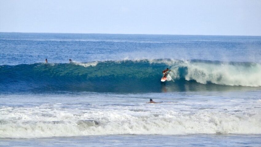 A surfer on a wave in Santa Teresa and no wondering where can I surf in Costa Rica
