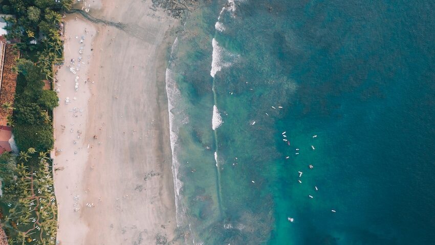 Tamarindo with blue waters, beach and greenery from above in Costa Rica