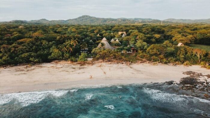 Tamarindo with blue waters, beach and greenery looking inland