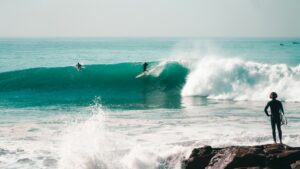 A surfer on a big wave in Taghazout and not thinking where can I surf in Morocco