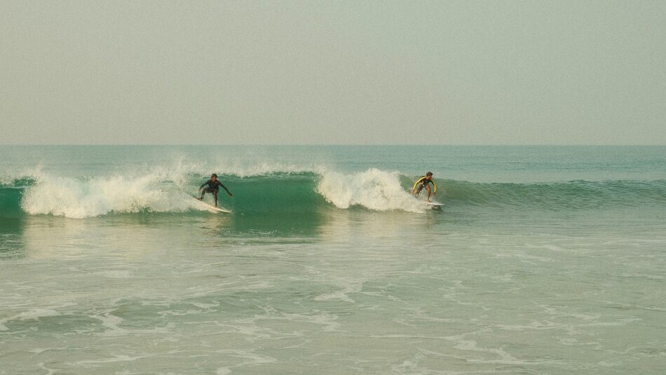 two surfers on waves in Tamraght Morocco