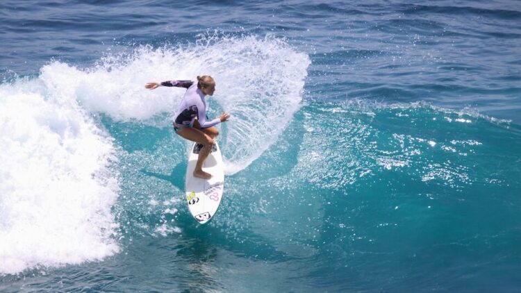 A surfer doing a cut back on a surfboard in Uluwatu Indonesia