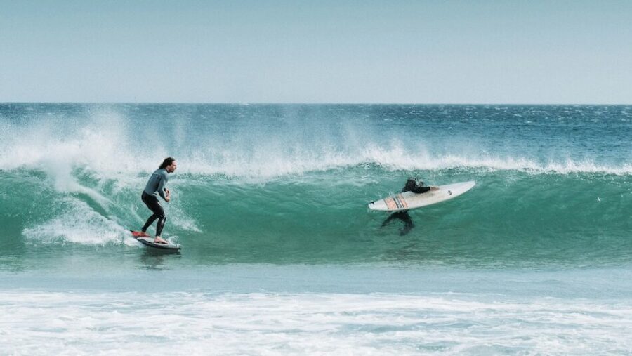 A surfer in Peniche catching a wave