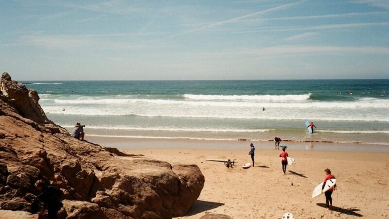 Peniche beginner surfers walking into the surf