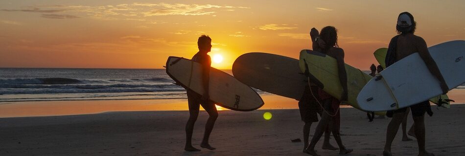 Surfers at sunset in Peniche who was also researched Peniche vs Ericeira beginner surf comparison