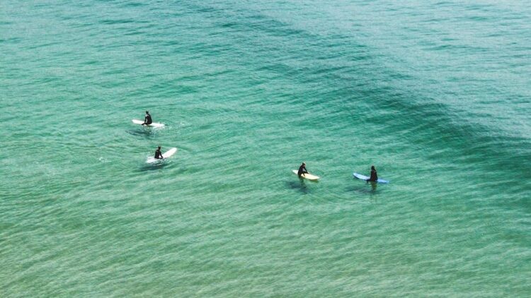 People sitting on surfboards in the water Tamraght