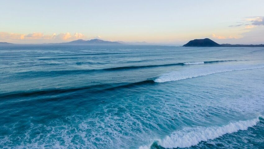 Surf waves at Corralejo Canary Islands at sunset