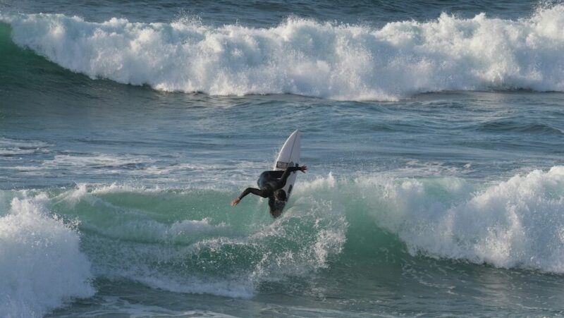 Surfer doing a turn on a wave in Ericeira Portugal