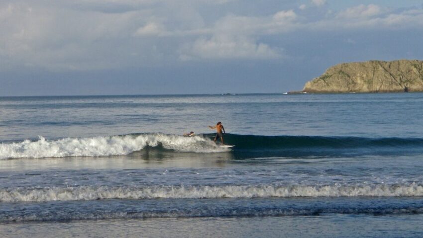 Surfer on a blue wave in Costa Rica