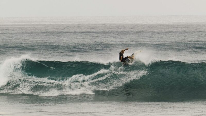 Surfer pulling a turn on a wave in Bali Indonesia