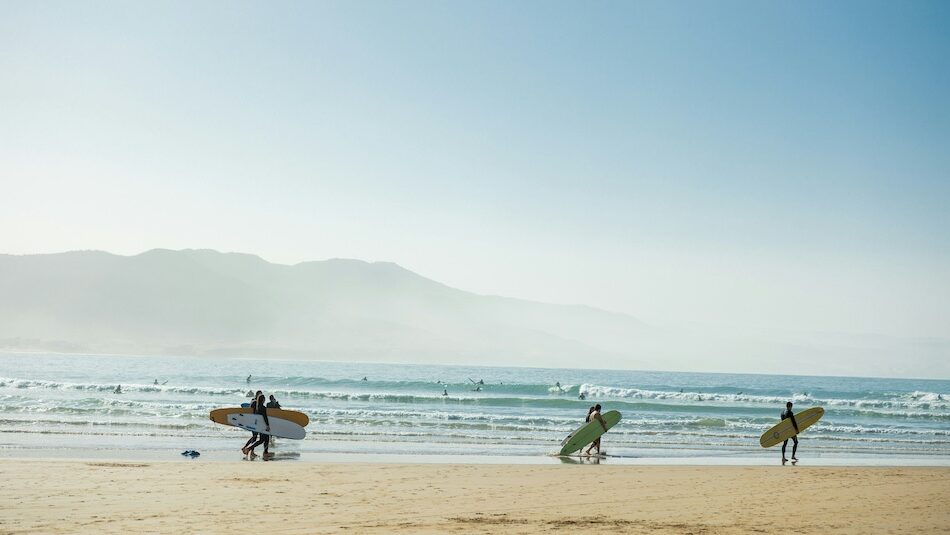 Surfers walking to the beach in Imsouane Morocco