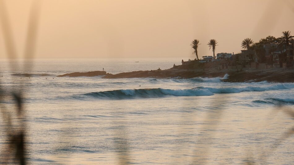Taghazout point break wave at sunset