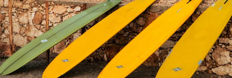 long malibu surfboards lined up when surfing Morocco without a car
