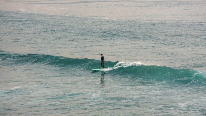 Beginner surfer on a wave in Tamraght Morocco